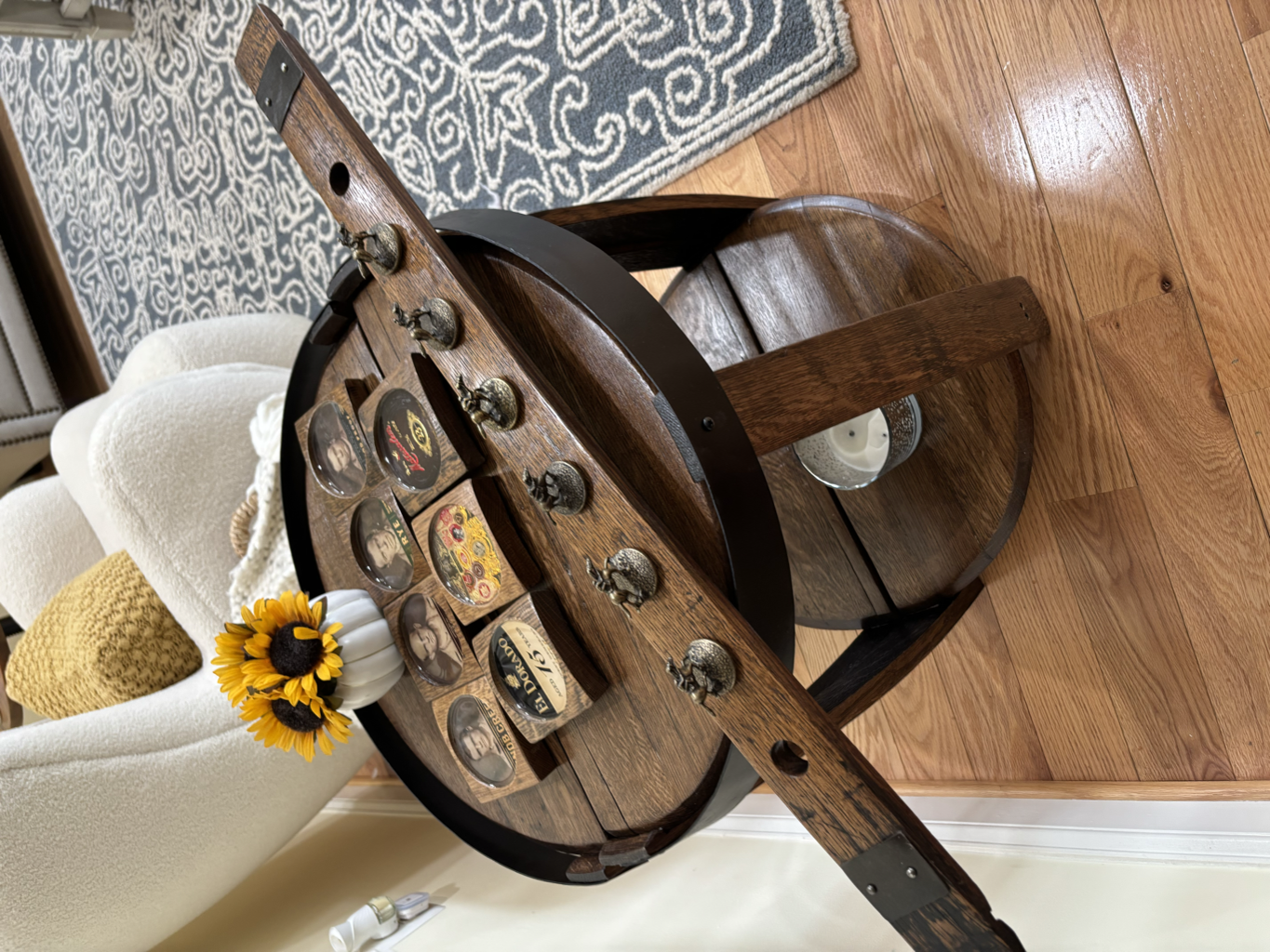 Barrel side table decorated with whiskey brand medallions