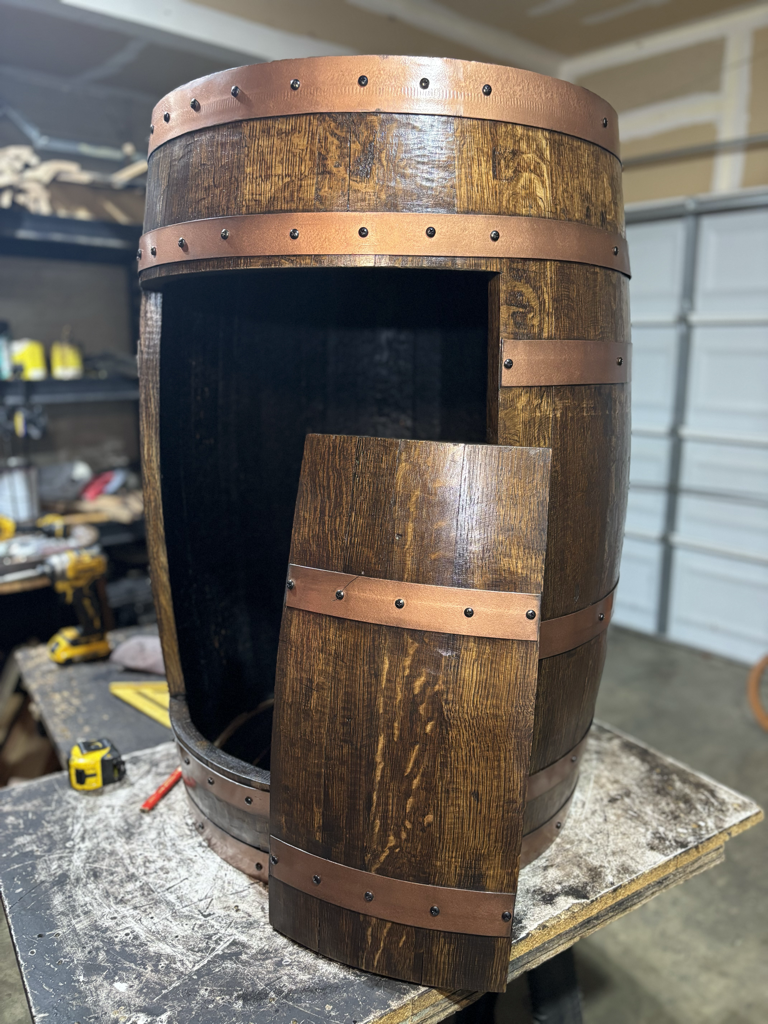 Whiskey barrel with opening cut for storage or pet bed